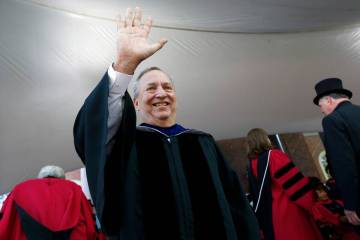 Former Harvard University president Larry Summers waves during Harvard commencement exercises, ...