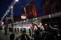 People watch the first practice of the Formula One Las Vegas Grand Prix auto race along the Las ...