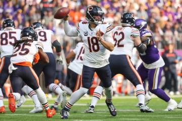 Chicago Bears quarterback Caleb Williams (18) passes during the first half of an NFL football g ...