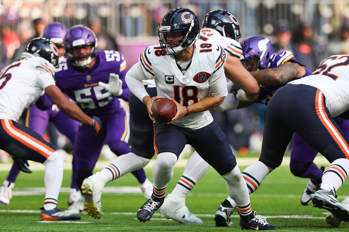 Chicago Bears quarterback Caleb Williams (18) handles the ball against the Minnesota Vikings du ...