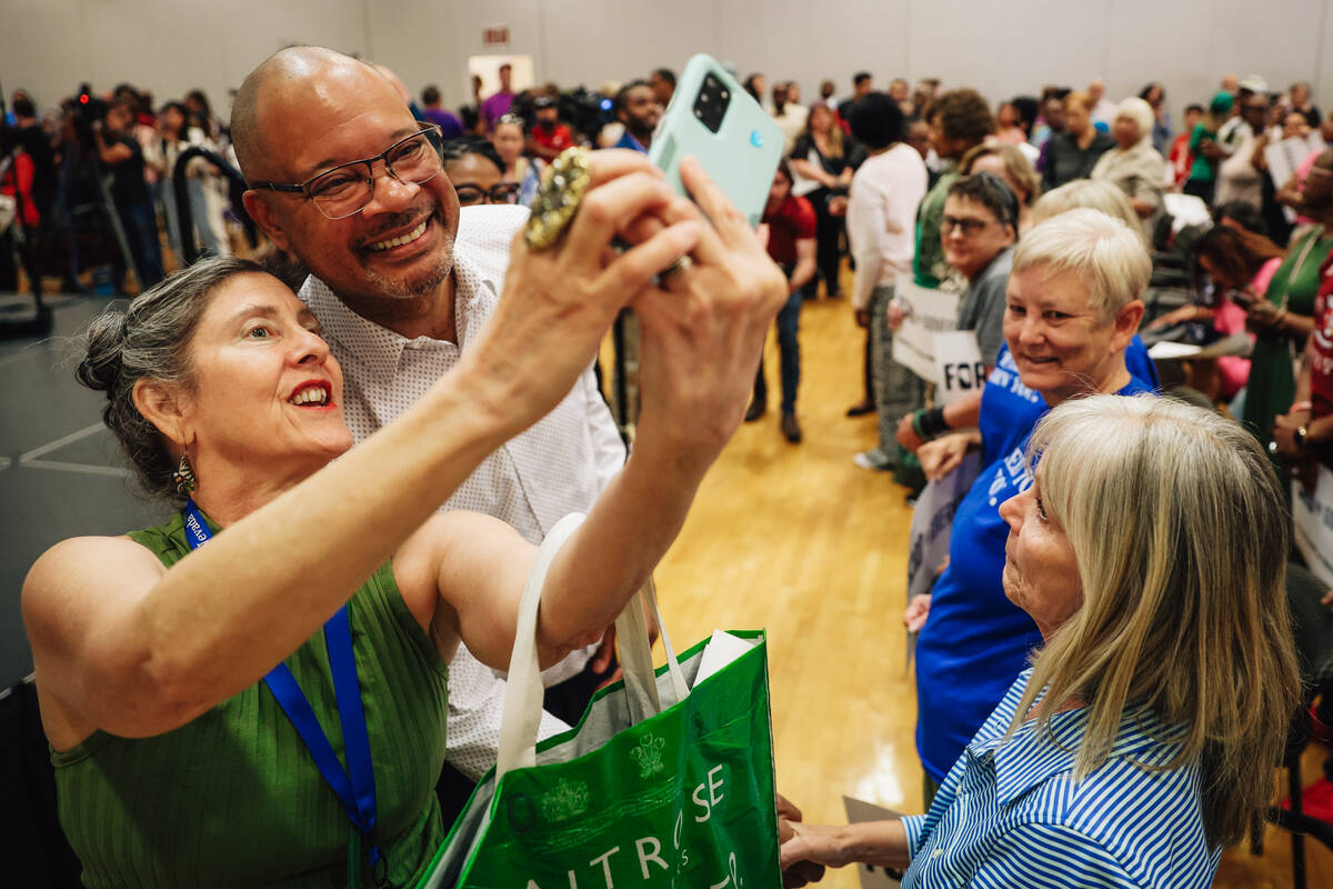 Nevada Attorney General Aaron Ford, right, takes selfies with supporters during his governor ca ...