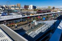 People walk about the team hospitality area with the track and skyline beyond during a tour of ...