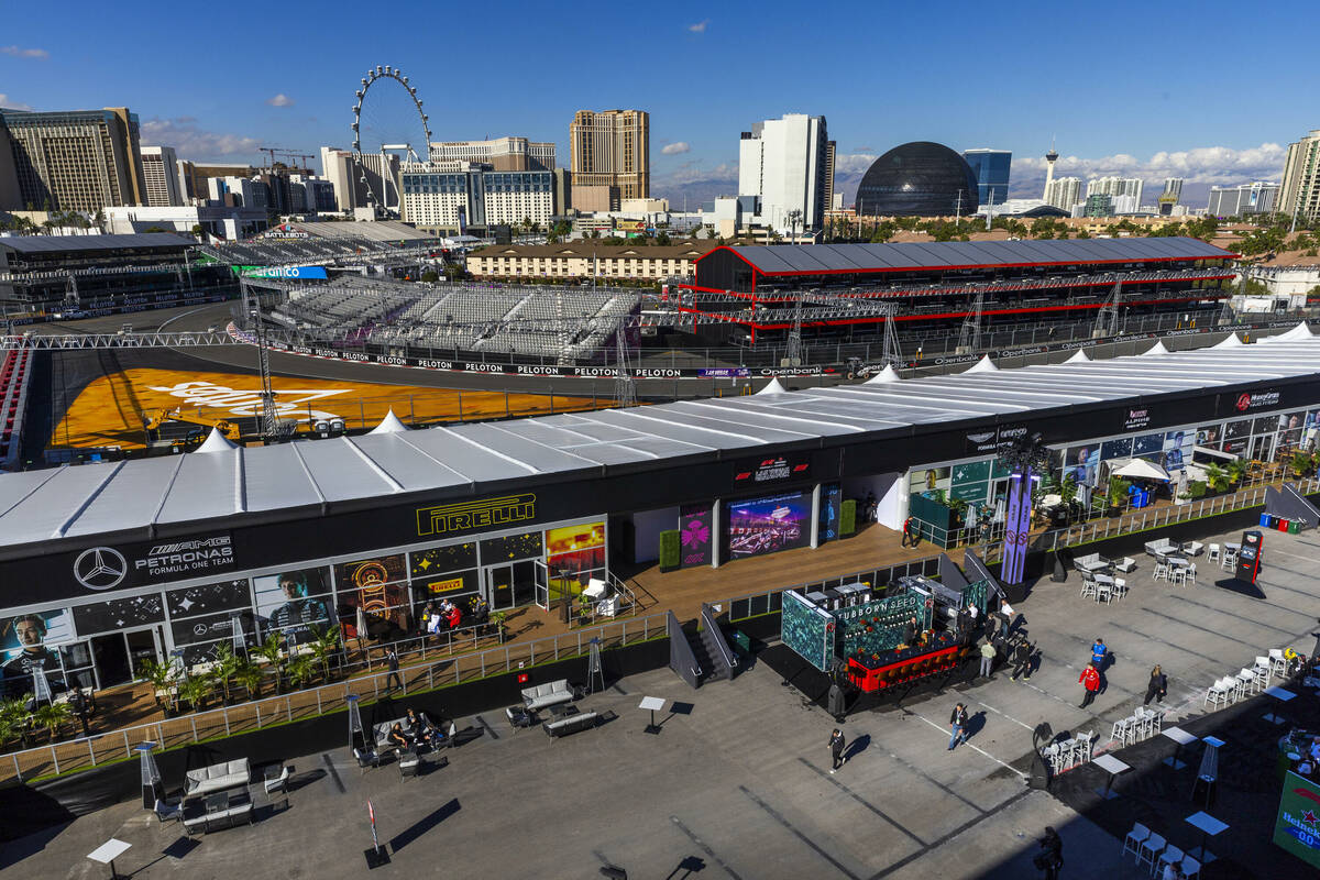 People walk about the team hospitality area with the track and skyline beyond during a tour of ...