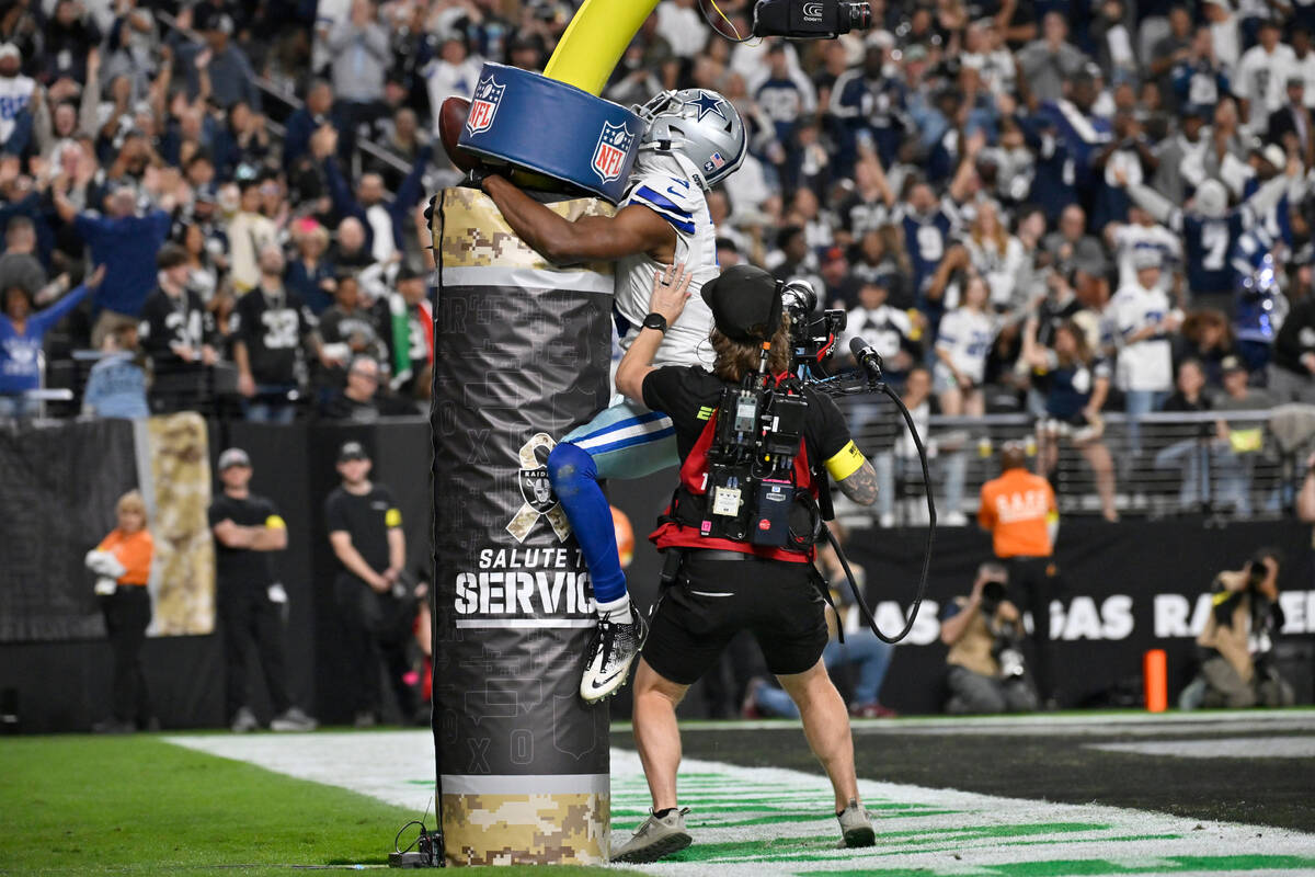 An ESPN television cameraman stands nearby as Dallas Cowboys wide receiver George Pickens (3) c ...