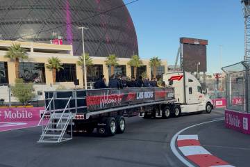 A flatbed truck taking fans on a lap of the Las Vegas Grand Prix circuit passes Sphere on Thurs ...