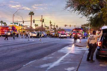 Metropolitan Police officers work with Las Vegas and North Las Vegas firefighters as numerous v ...