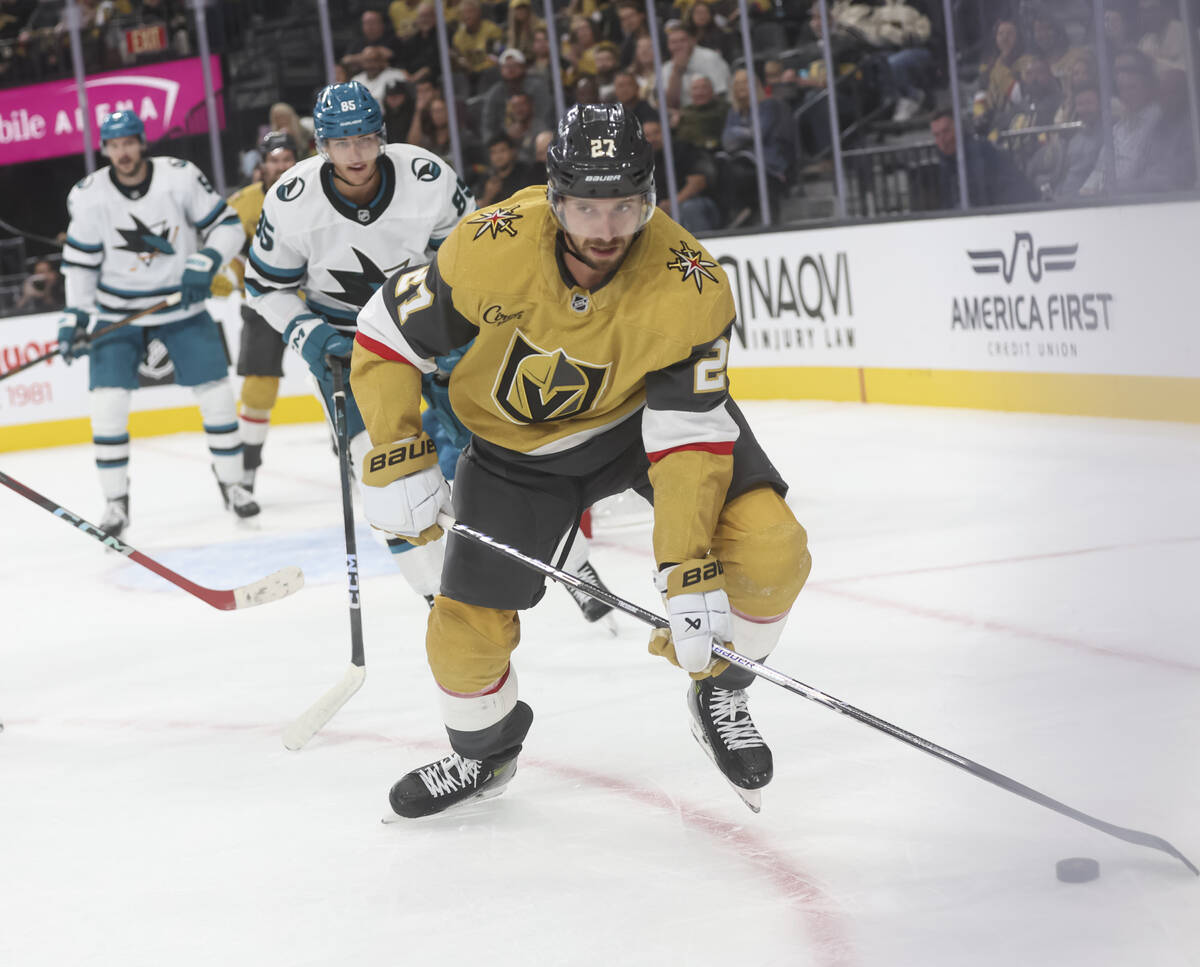Golden Knights defenseman Shea Theodore (27) skates with the puck during the first period of an ...