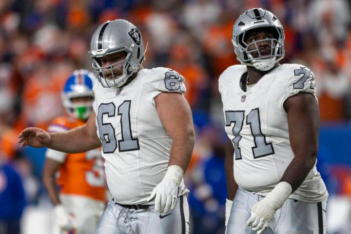 Raiders offensive tackle DJ Glaze (71) and guard Jordan Meredith (61) react to the team coming ...