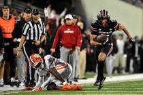 Clemson cornerback Branden Strozier (1) falls as he attempts to tackle Louisville wide receiver ...
