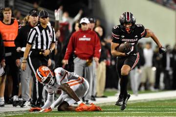 Clemson cornerback Branden Strozier (1) falls as he attempts to tackle Louisville wide receiver ...