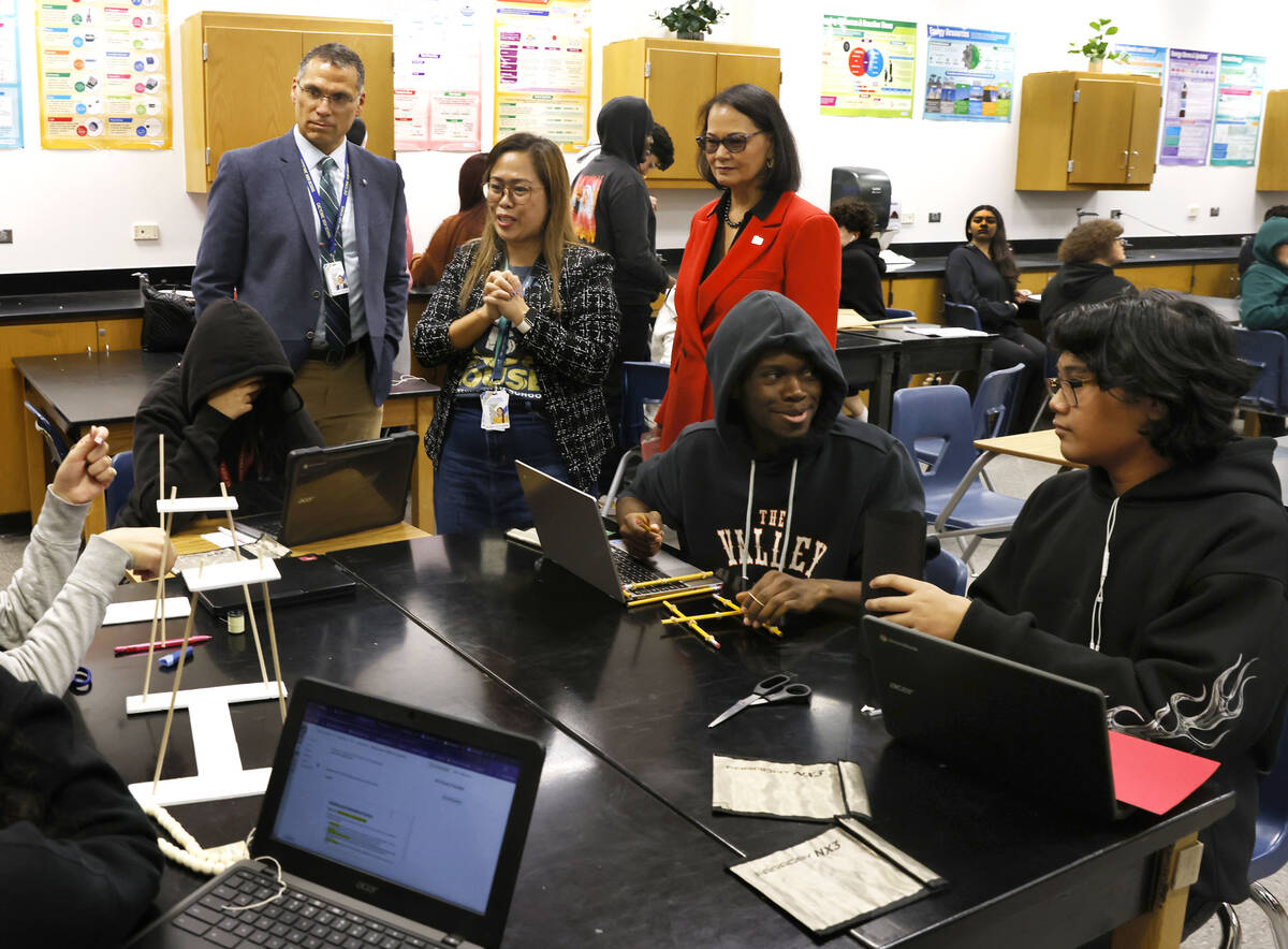 Ailen Ciruela, center, a physical science teacher at Cheyenne High School, speaks as Principal ...