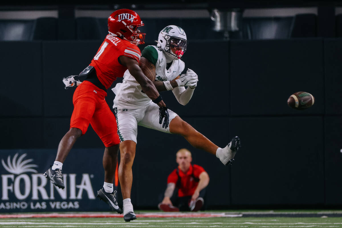 UNLV defensive back Andrew Powdrell (4) bats down a pass intended for Hawaii wide receiver Kars ...