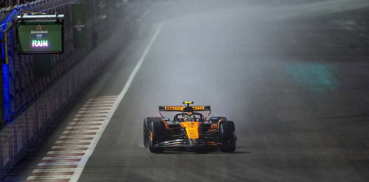 McLaren driver Lando Norris approaches turn 1 in the rain during the qualifying race at the Las ...