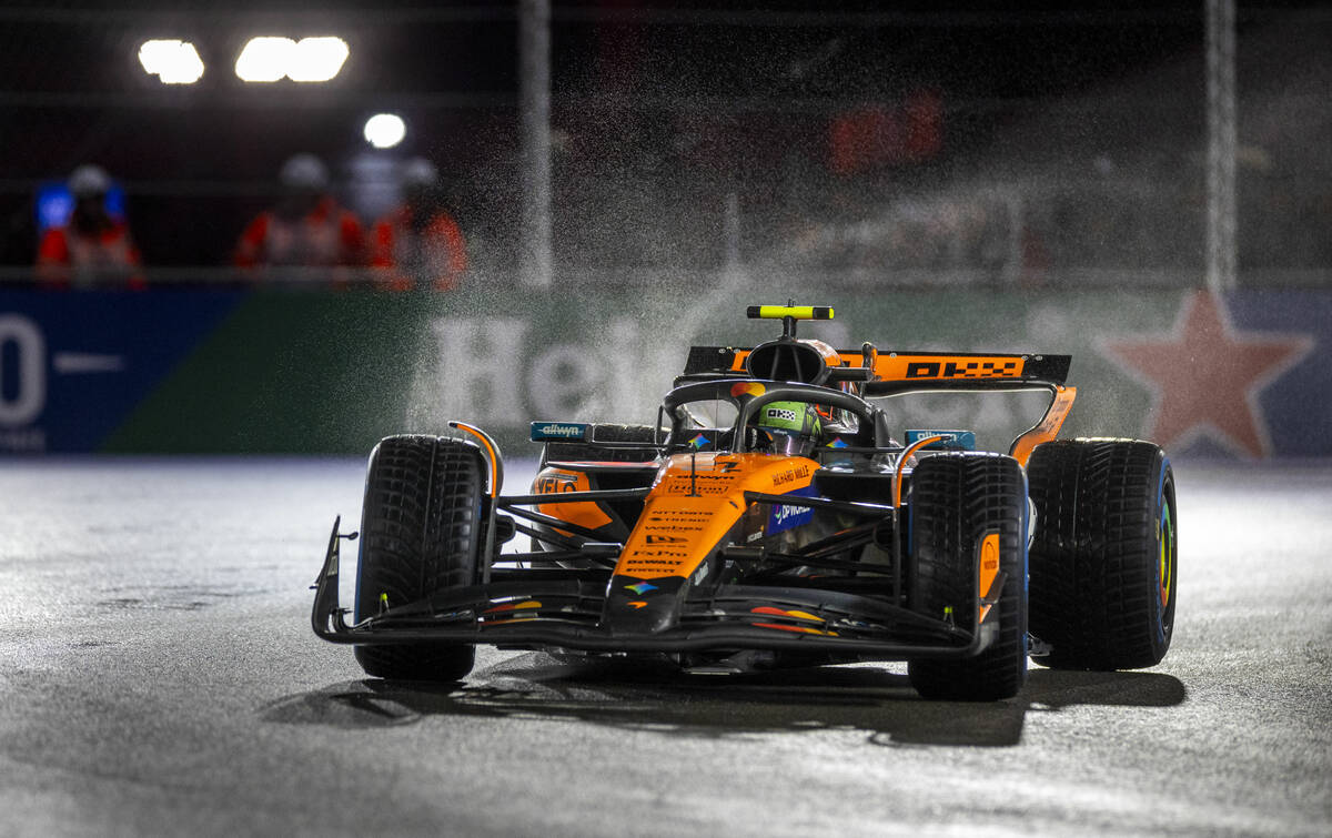McLaren driver Lando Norris navigates turn 1 in the rain during the qualifying race at the Las ...