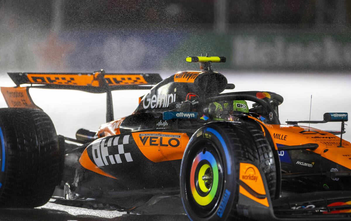 McLaren driver Lando Norris navigates turn 1 in the rain during the qualifying race at the Las ...