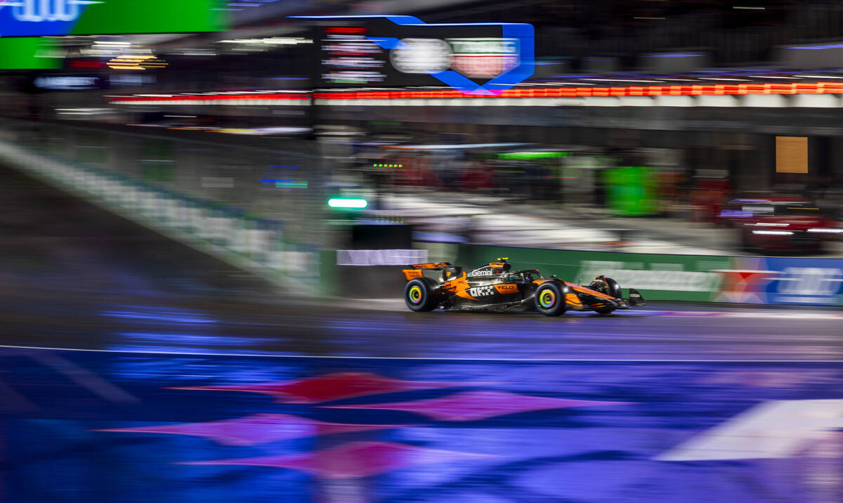 McLaren driver Lando Norris navigates turn 1 in the rain during the qualifying race at the Las ...