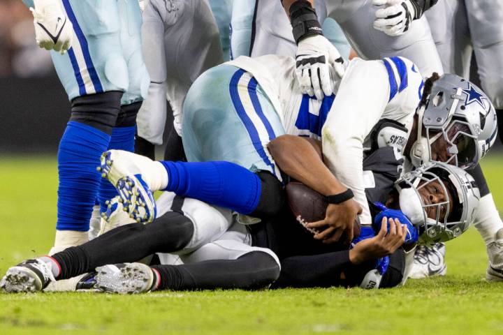 Dallas Cowboys defensive tackle Quinnen Williams (92) sacks Raiders quarterback Geno Smith (7) ...
