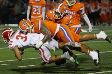 Bishop Gorman defensive lineman Prince Williams (41) tackles Mater Dei running back Justin Lewi ...