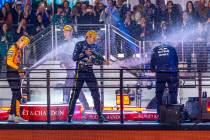 Race winner Red Bull driver Max Verstappen (1) sprays champagne with second place McLaren drive ...