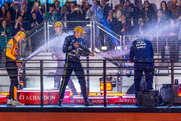Race winner Red Bull driver Max Verstappen (1) sprays champagne with second place McLaren drive ...
