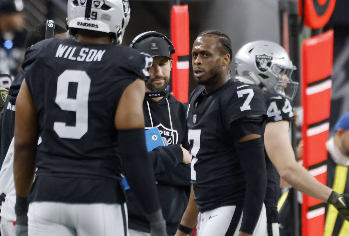 Raiders quarterback Geno Smith (7) looks toward defensive end Tyree Wilson (9) as he leaves the ...