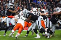 Raiders quarterback Geno Smith (7) throws the ball under pressure from Cleveland Browns defensi ...