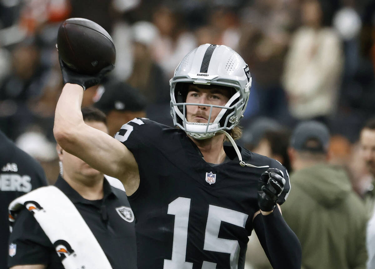Raiders quarterback Kenny Pickett (15) throws a pass during a warm up before an NFL football ga ...