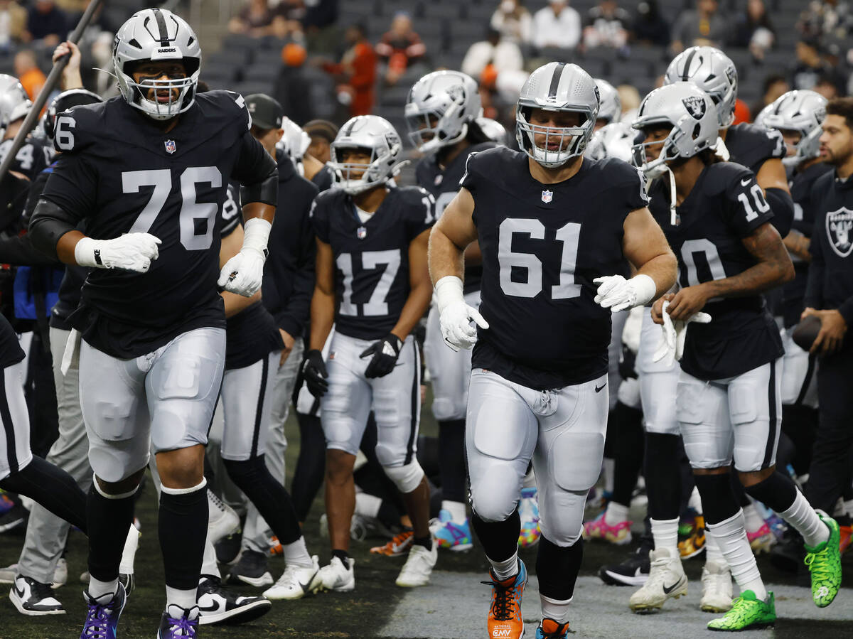 Raiders players take the field to warm up before an NFL football game against the Cleveland Bro ...