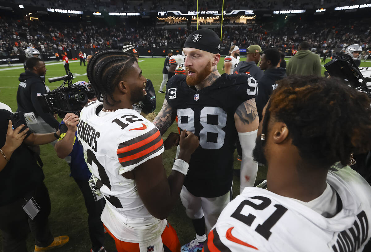 Cleveland Browns quarterback Shedeur Sanders (12) talks with Raiders defensive end Maxx Crosby ...