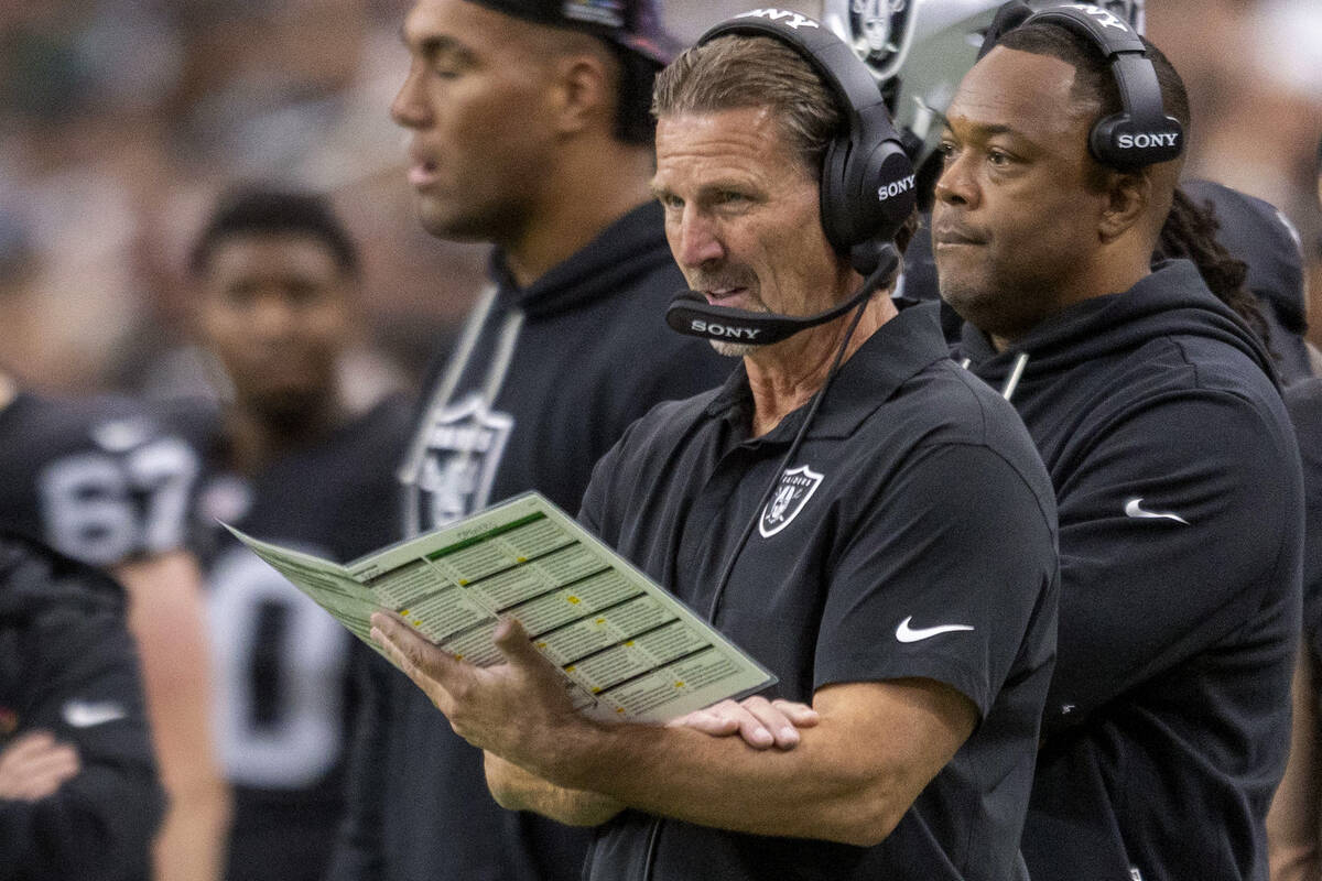 Raiders quarterback coach Greg Olson draws up a play during the second half of an NFL game agai ...