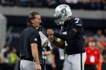 Raiders quarterback Geno Smith (7) discusses with quarterbacks coach Greg Olson during the seco ...