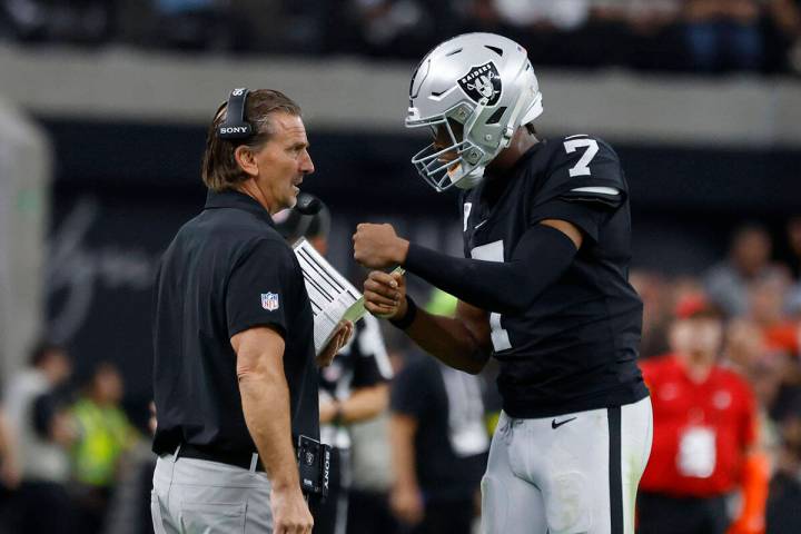 Raiders quarterback Geno Smith (7) discusses with quarterbacks coach Greg Olson during the seco ...