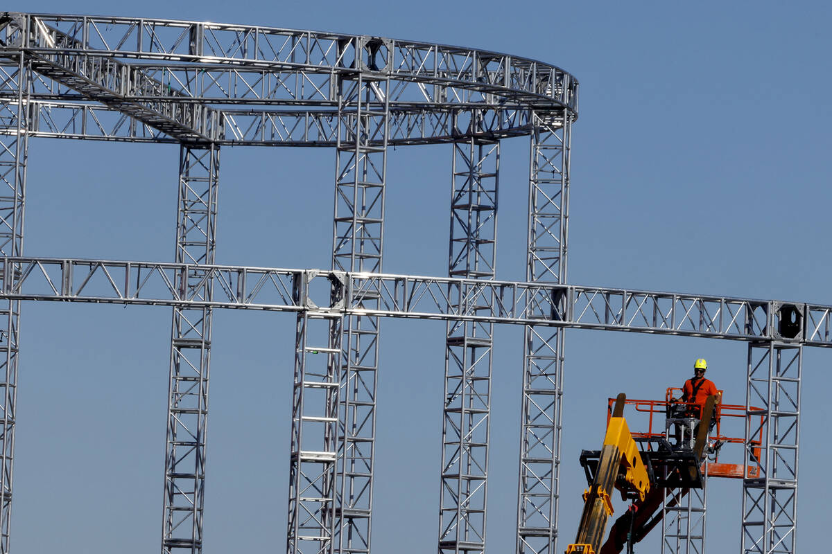 Workers are in the process of dismantling the Formula 1 Grand Prix lighting fixitures on Monday ...
