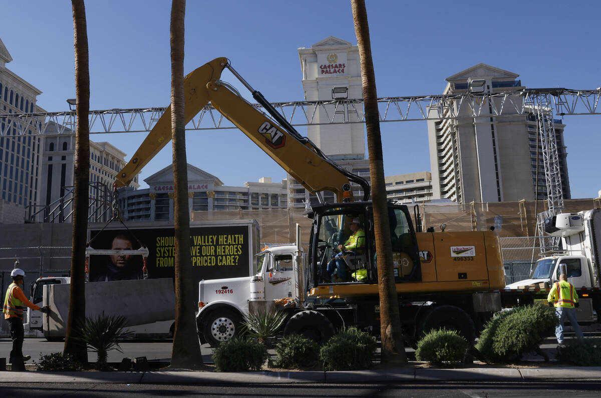 Workers are in the process of removing track barriers along the Formula 1 Grand Prix circuit on ...