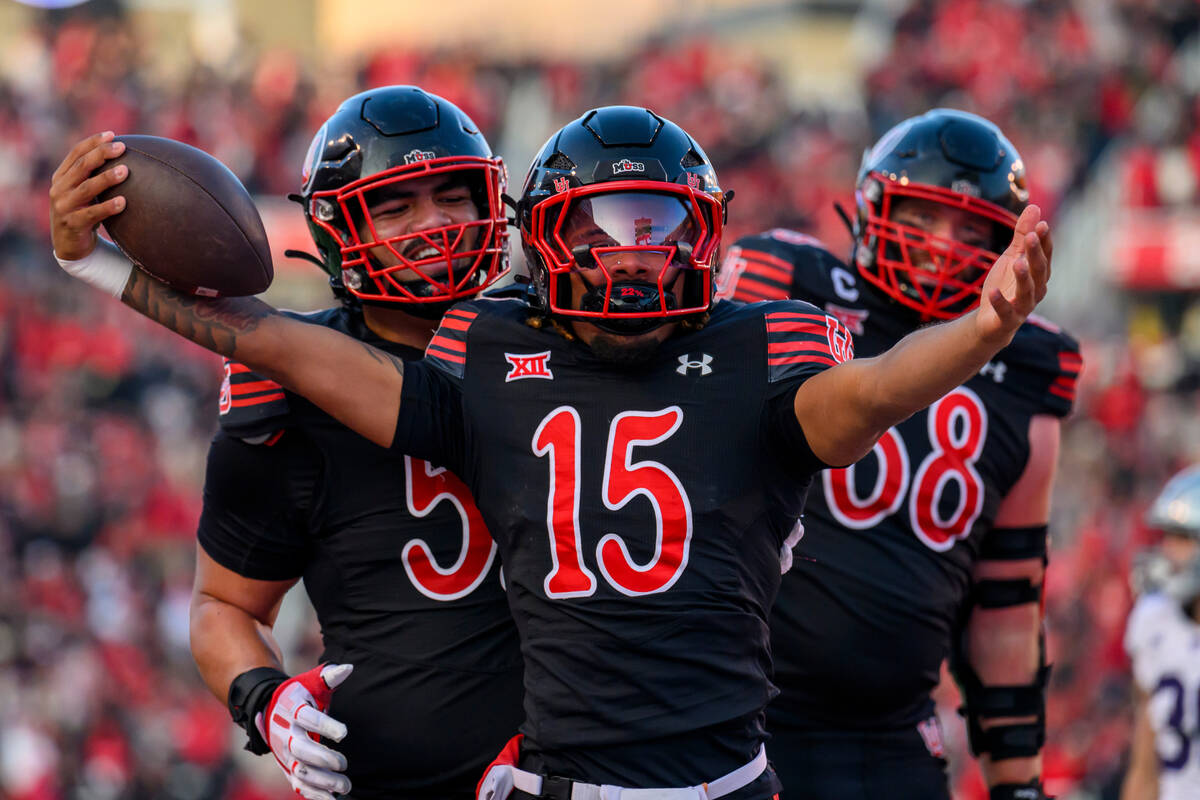 Utah quarterback Byrd Ficklin (15) celebrates with teammates Otto Tia, left, and Jaren Kump, ri ...