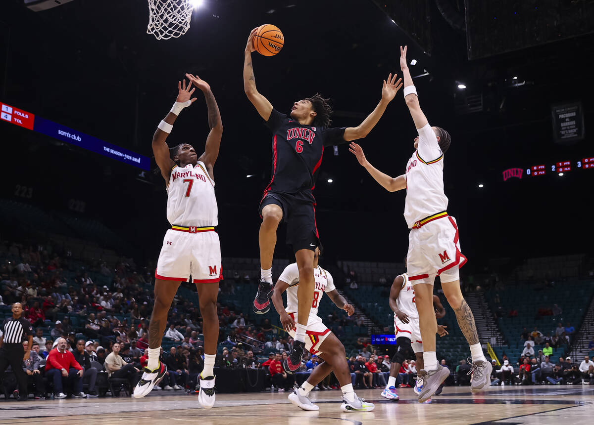 UNLV forward Tyrin Jones (6) lays up the ball between Maryland Terrapins guards Andre Mills (7) ...