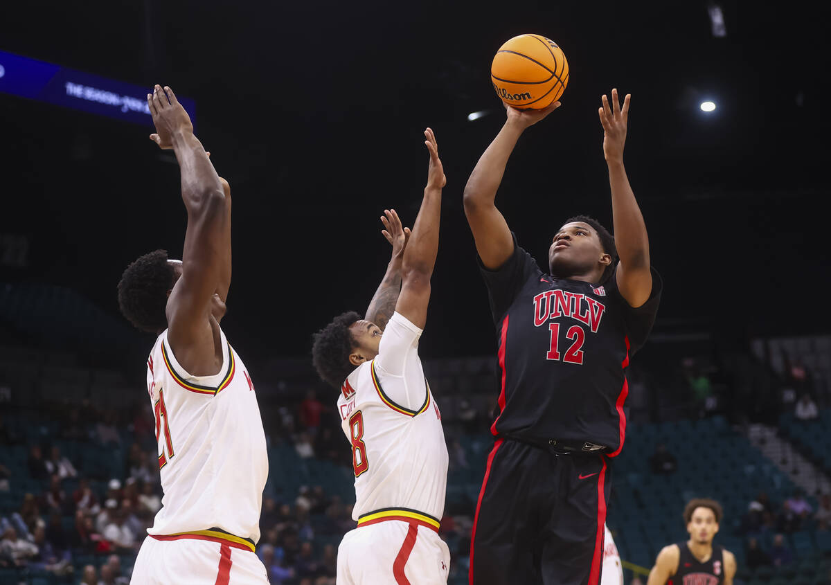 UNLV guard Issac Williamson (12) shoots under pressure from Maryland Terrapins forward Pharrel ...