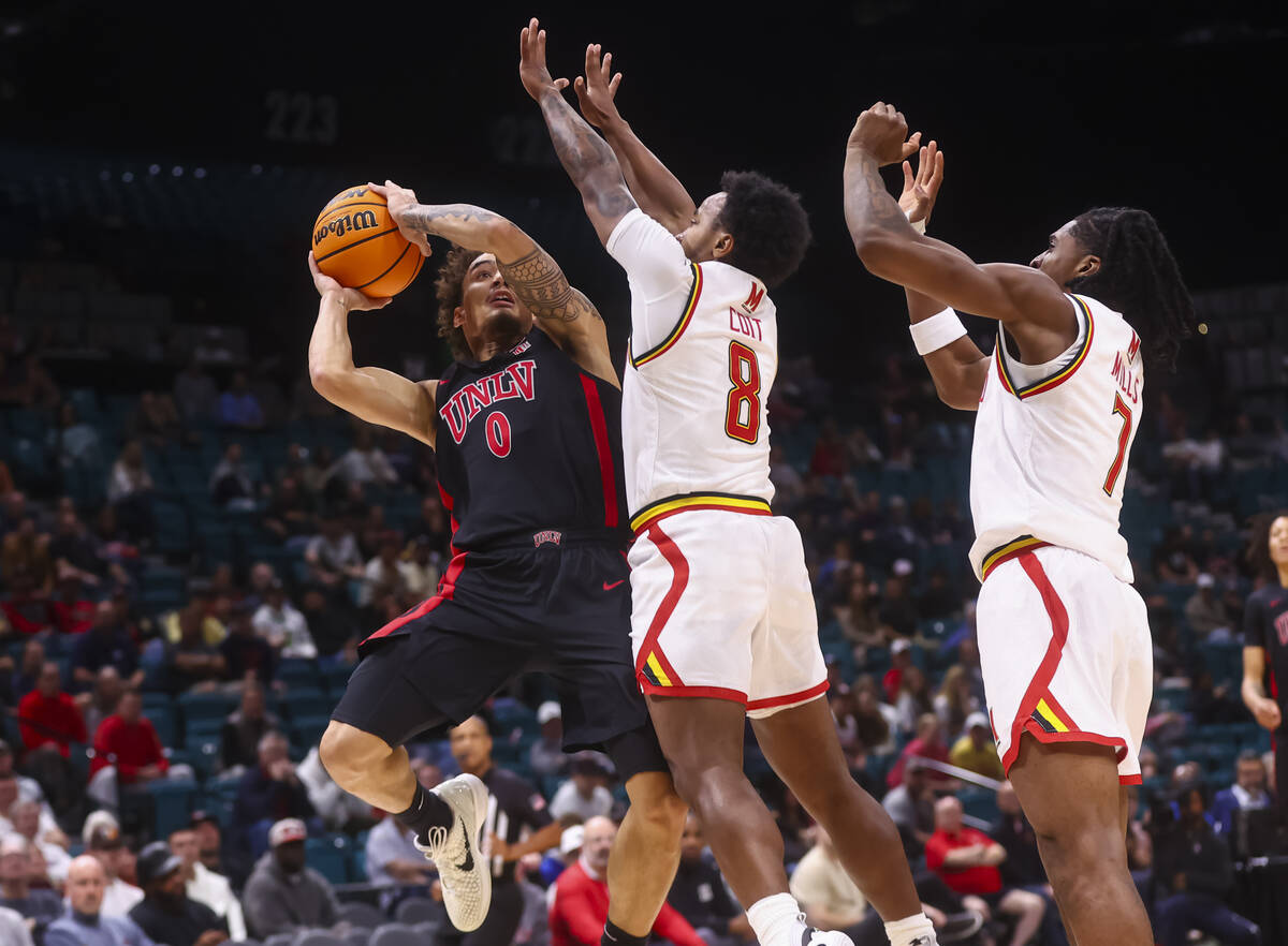 UNLV guard Dravyn Gibbs-Lawhorn (0) tries to shoot under pressure from Maryland Terrapins guard ...