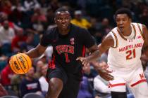 UNLV forward Ladji Dembele (1) drives to the basket past Maryland Terrapins forward Pharrel Pay ...