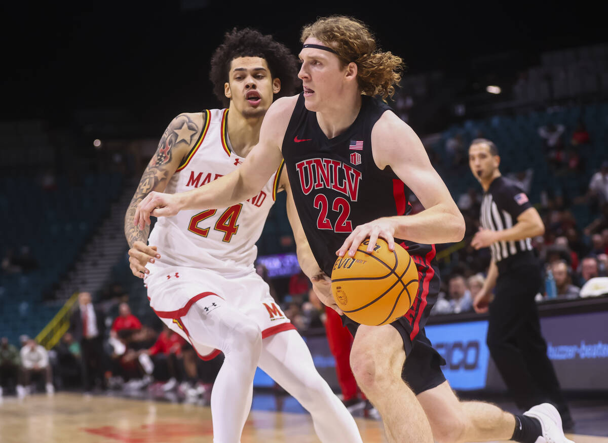 UNLV forward Walter Brown (22) drives to the basket past Maryland Terrapins forward Aleks Alsto ...
