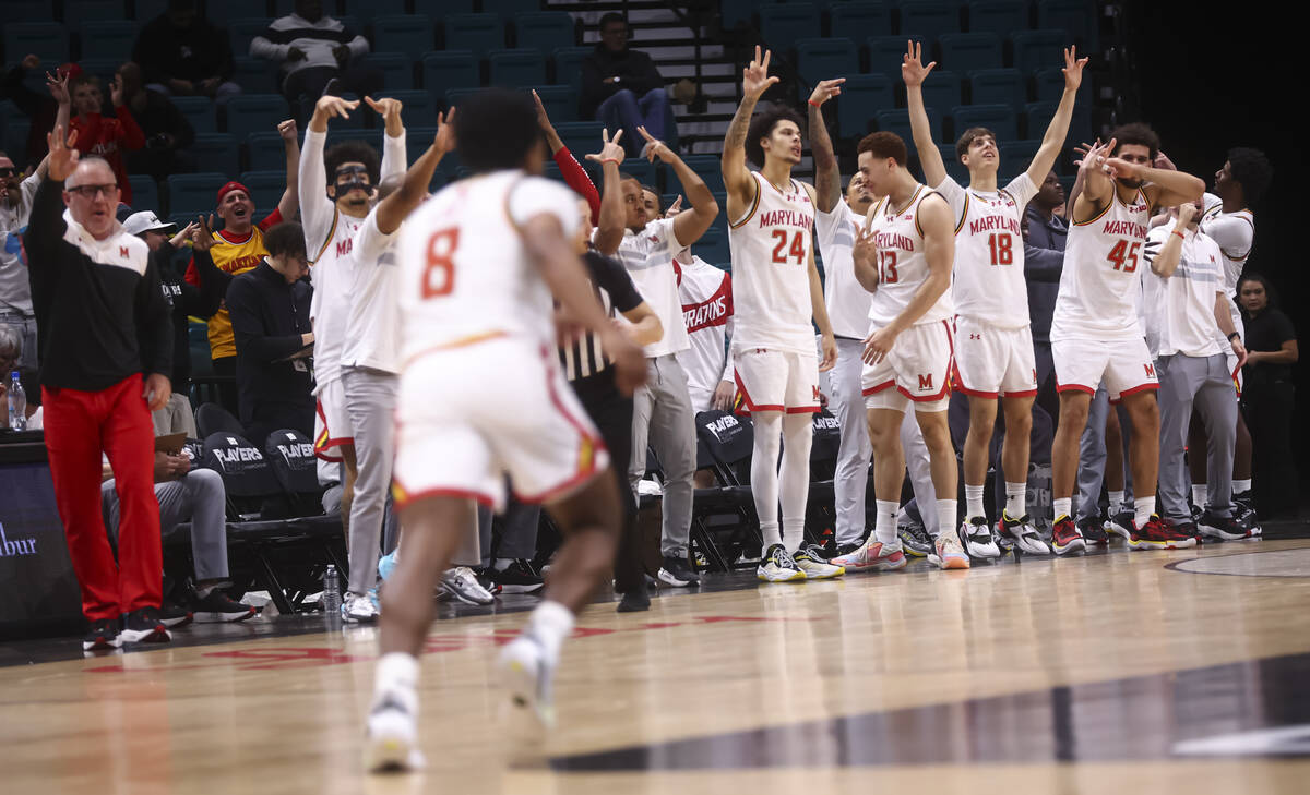 Maryland Terrapins players celebrate a three-pointer by Maryland Terrapins guard David Coit (8) ...