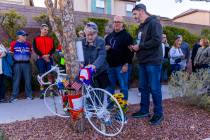 Linda Sterner and her son Shane, center, sign the bike dedicated to her husband and his father, ...