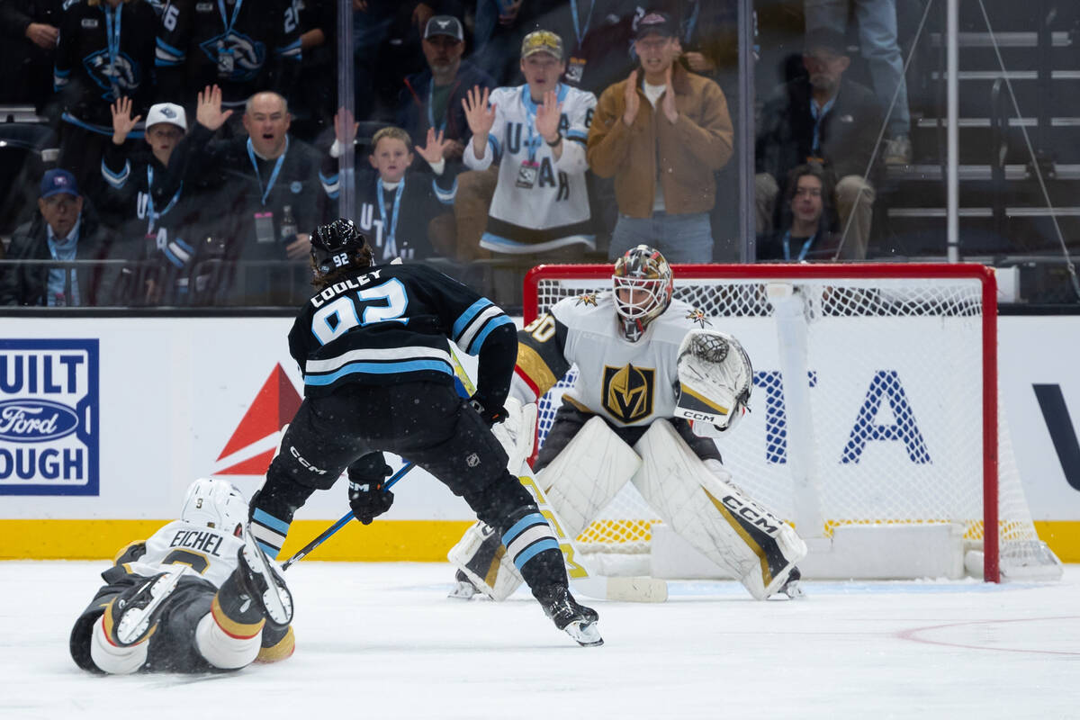 Vegas Golden Knights goalkeeper Carl Lindbom, right, prepares to defend a shot on goal as Utah ...