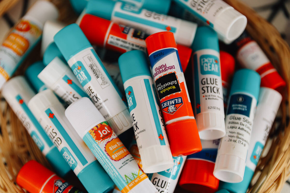 Glue sits out for crafters during a junk journaling meet-up at Shop Mama Sage in Container Park ...