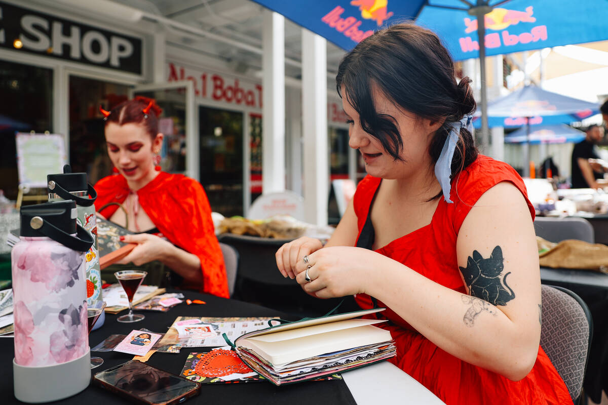 Chloe Gilbert crafts during a junk journaling meet-up at Shop Mama Sage in Container Park on Sa ...