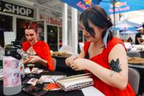 Chloe Gilbert crafts during a junk journaling meet-up at Shop Mama Sage in Container Park on Sa ...