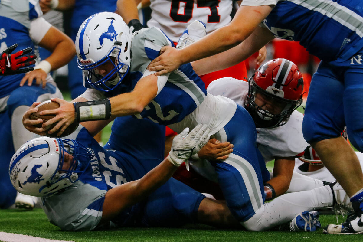 Needles quarterback Hudson Smith (12) reaches for enough extra yardage to score a touchdown dur ...