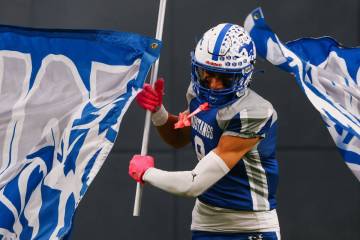 Needles’ Gabriel Rodriguez (8) bursts through the banner as his team enters the stadium ...