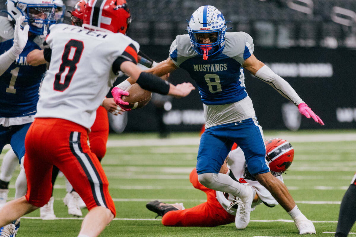 Needles wide receiver Gabriel Rodriguez (8) dodges Pershing County defensive players on his way ...