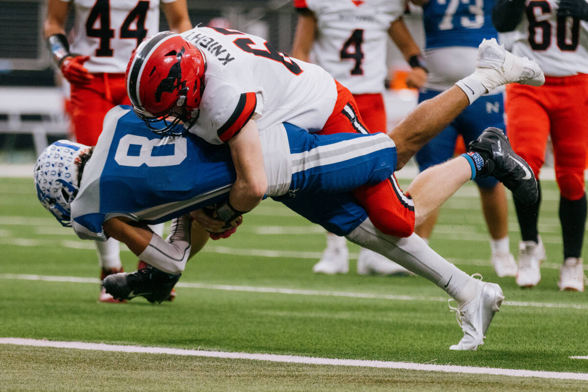 Pershing County defensive lineman Israel Knight (67) tackles Needles wide receiver Gabriel Rodr ...
